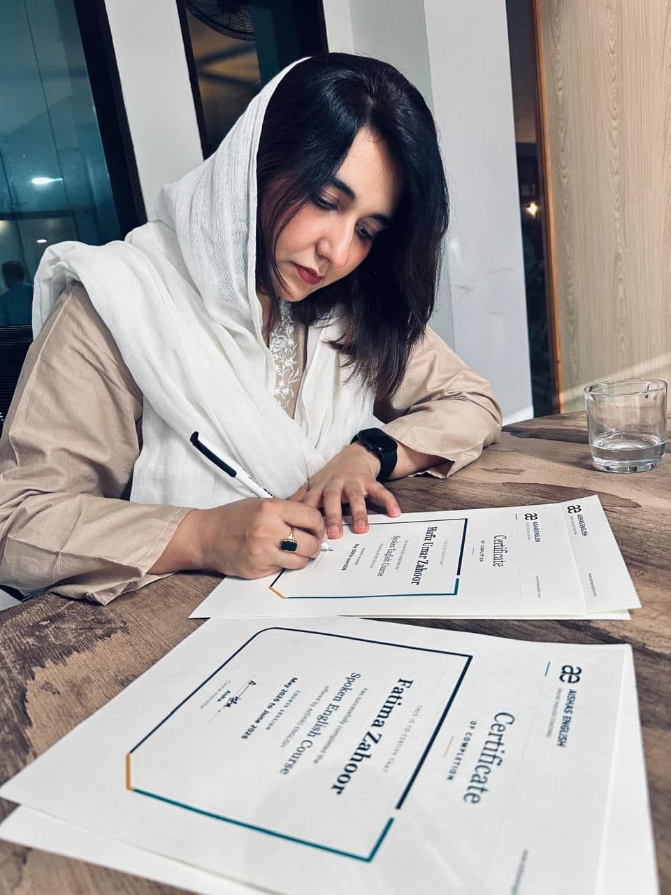 Aisha signing professional training certificates